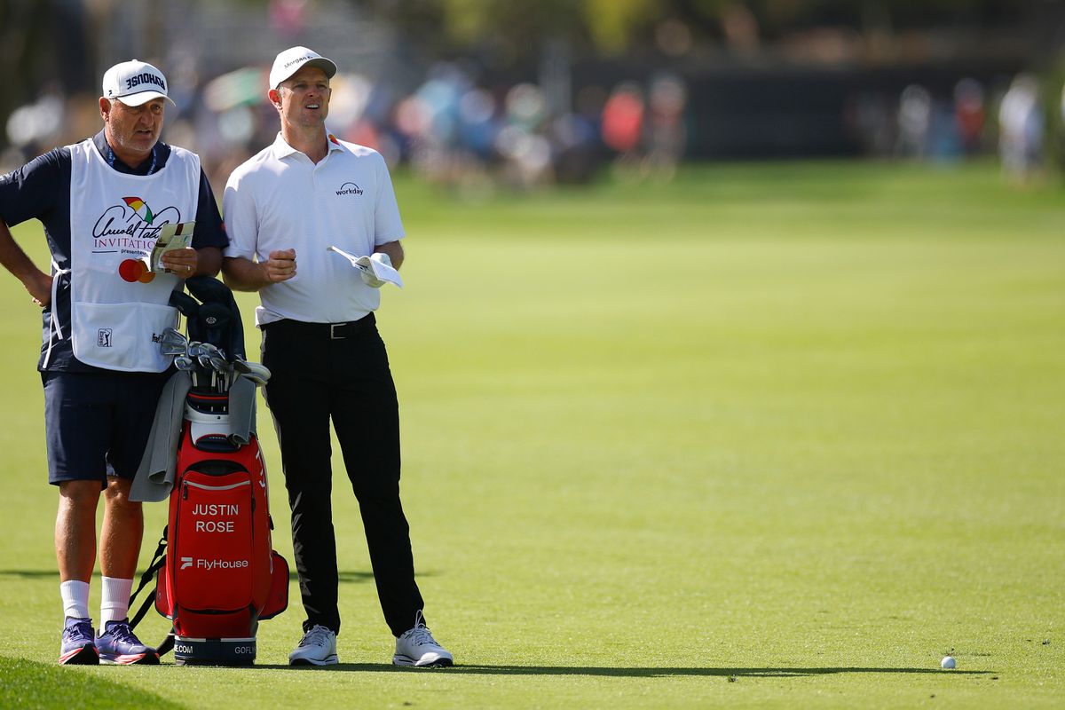 Justin Rose talks with caddie Mark Fulcher