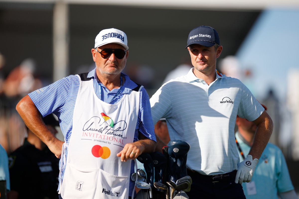 Justin Rose looks on with caddie Mark Fulcher