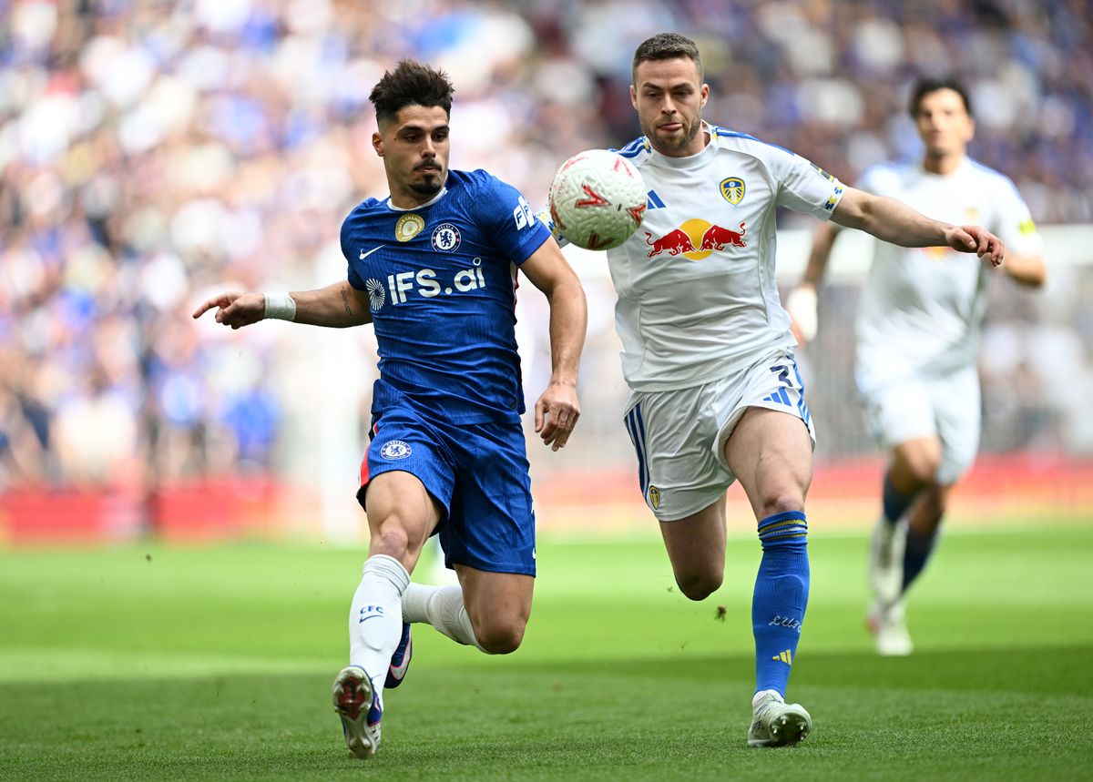 Pedro Neto of Chelsea and Gabriel Gudmundsson of Leeds United compete for the ball