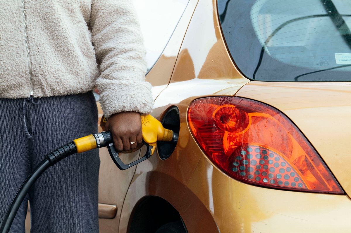 A woman fills up her diesel car. Diesel at €2.029, SP98 at €1.879. War in Iran, increase in diesel prices. Illustration of a person filling up with fuel and prices at a gas station. France, Ville-Dieu-du-Temple, March 10, 2026.