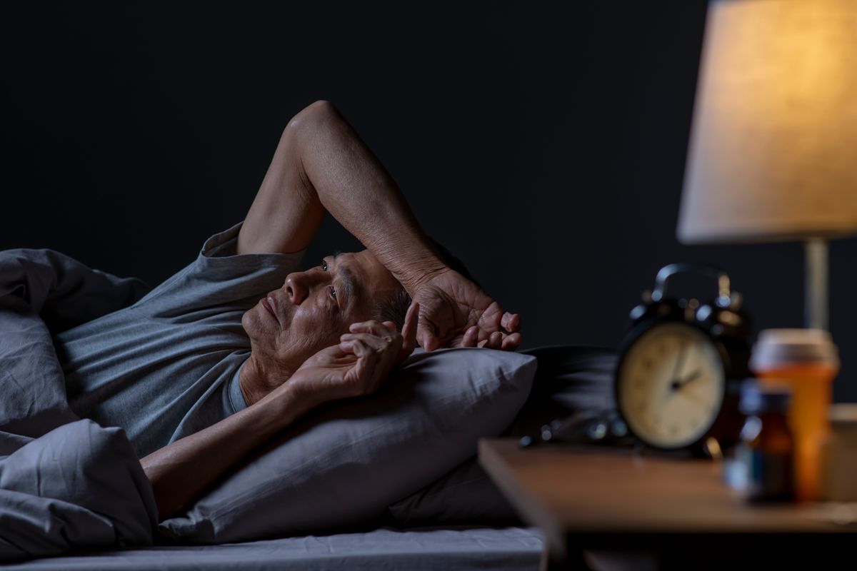 Man lying in bed cannot sleep from insomnia