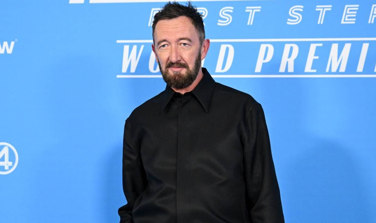 A bearded man in a black shirt.