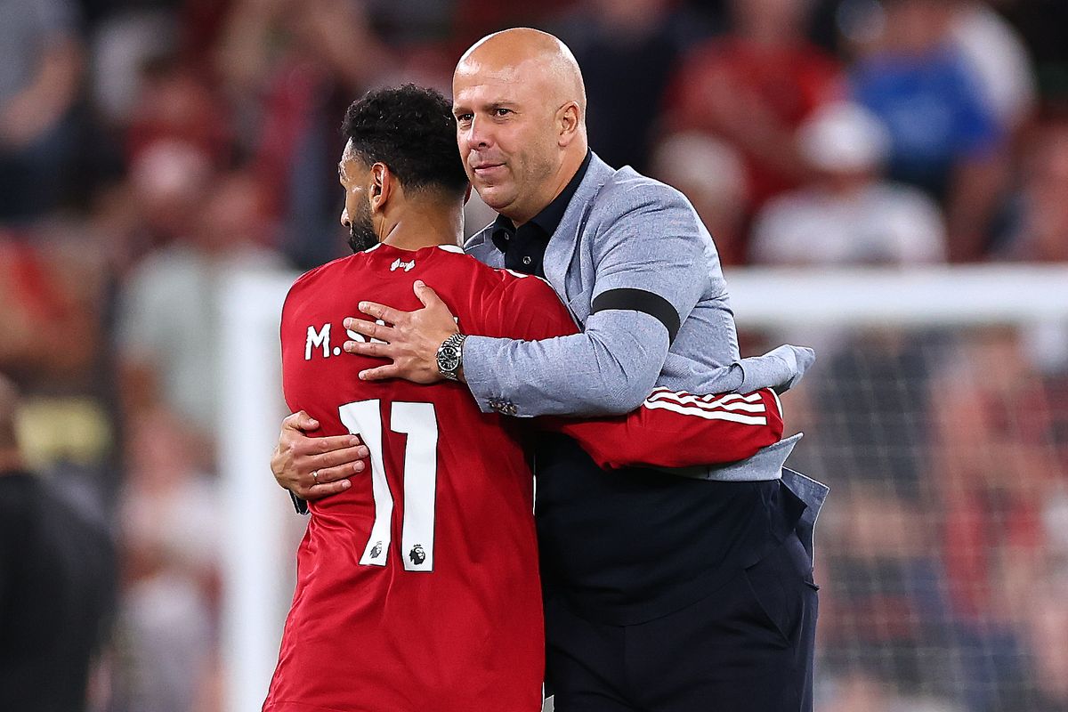 LIVERPOOL, ENGLAND - AUGUST 15: Arne Slot manager / head coach of Liverpool hugs Mohamed Salah of Liverpool at full time during the Premier League match between Liverpool and Bournemouth at Anfield on August 15, 2025 in Liverpool, England. (Photo by Robbie Jay Barratt - AMA/Getty Images)