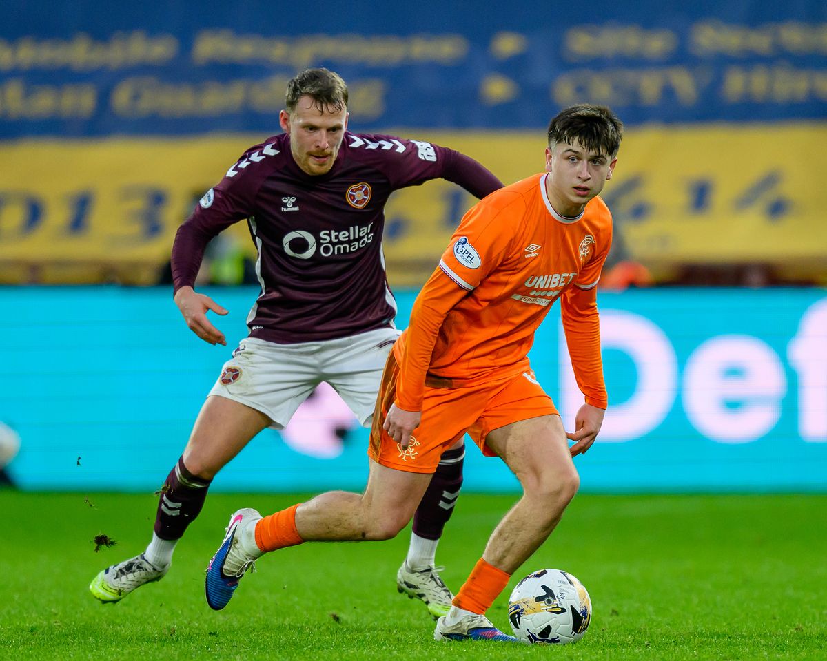 EDINBURGH, SCOTLAND - DECEMBER 21: Mikey Moore of Rangers (R) shields the ball from Stephen Kingsley of Hearts during the William Hill SPFL Premiership match between Heart of Midlothian and Rangers at Tynecastle Park on December 21, 2025 in Edinburgh, Scotland. (Photo by Malcolm Mackenzie/Getty Images)
