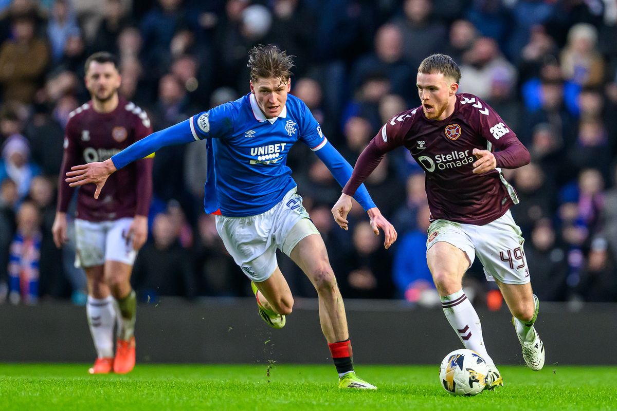GLASGOW, SCOTLAND - FEBRUARY 15: Marc Leonard (R) of Hearts runs past Ryan Naderi of Rangers during the William Hill Premiership match between Rangers and Heart of Midlothian at Ibrox Stadium on February 15, 2026 in Glasgow, Scotland. (Photo by Malcolm Mackenzie/Getty Images)