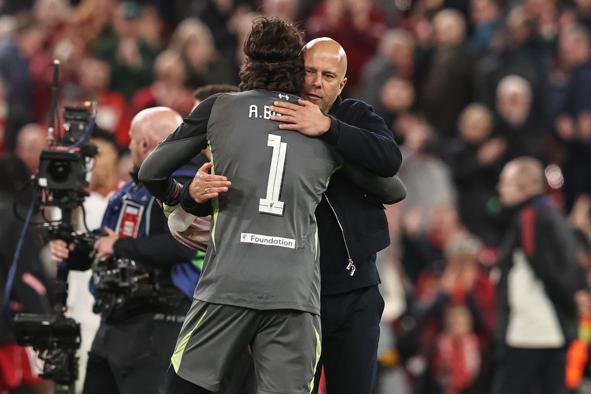 Arne Slot, manager of Liverpool, embraces Liverpool goalkeeper Alisson Becker after the win during the UEFA Champions League last 16 second leg match between Liverpool and Galatasaray at Anfield, Liverpool, United Kingdom, on March 18, 2026. (Photo by Alfie Cosgrove/News Images/NurPhoto via Getty Images)