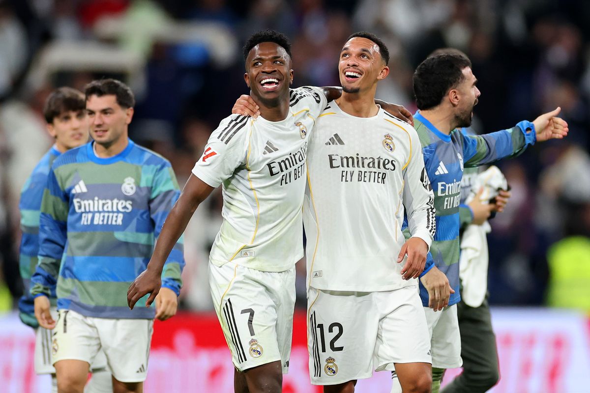 Vinicius Junior and Trent Alexander-Arnold of Real Madrid celebrate after the team's victory in the LaLiga EA Sports match between Real Madrid CF and Atletico de Madrid at Estadio Santiago Bernabeu on March 22, 2026 in Madrid, Spain