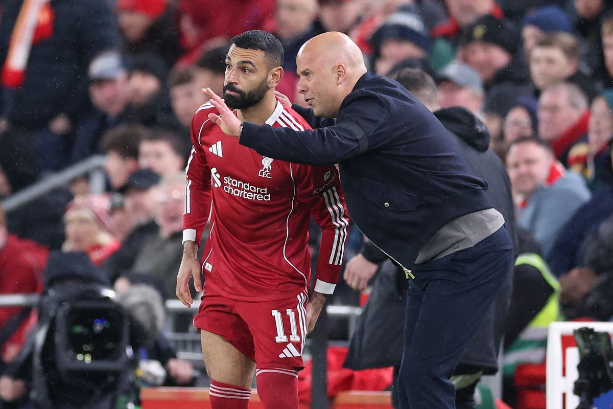 LIVERPOOL, ENGLAND - APRIL 14: Arne Slot, Manager of Liverpool talks with Mohamed Salah before bringing him on as substitute during the UEFA Champions League 2025/26 Quarter-Final Second Leg match between Liverpool FC and Paris Saint-Germain FC at Anfield on April 14, 2026 in Liverpool, England. (Photo by Alex Livesey - Danehouse/Getty Images)