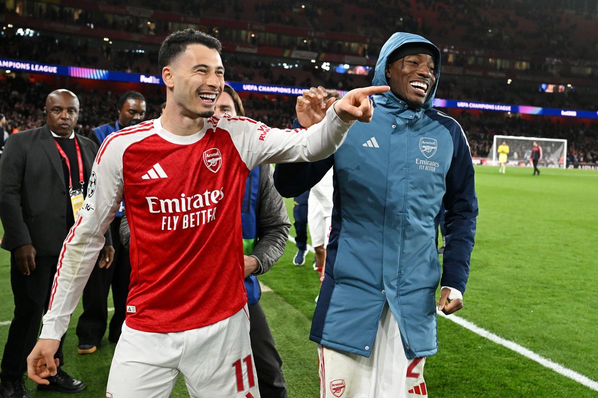 Gabriel Martinelli and Noni Madueke of Arsenal celebrate following the team's victory in the UEFA Champions League 2025/26 Quarter-Final Second Leg match between Arsenal FC and Sporting Clube de Portugal at Arsenal Stadium on April 15, 2026 in London, England