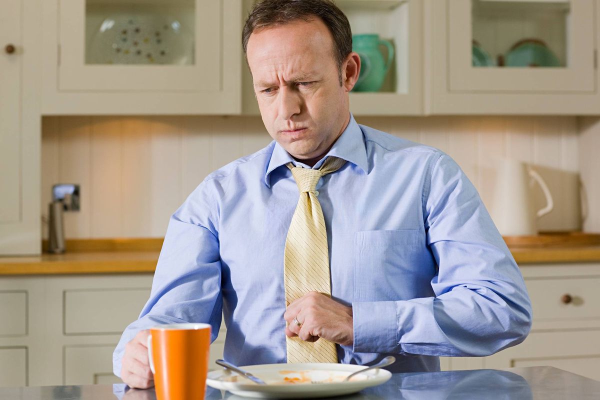Man feeling full from eating