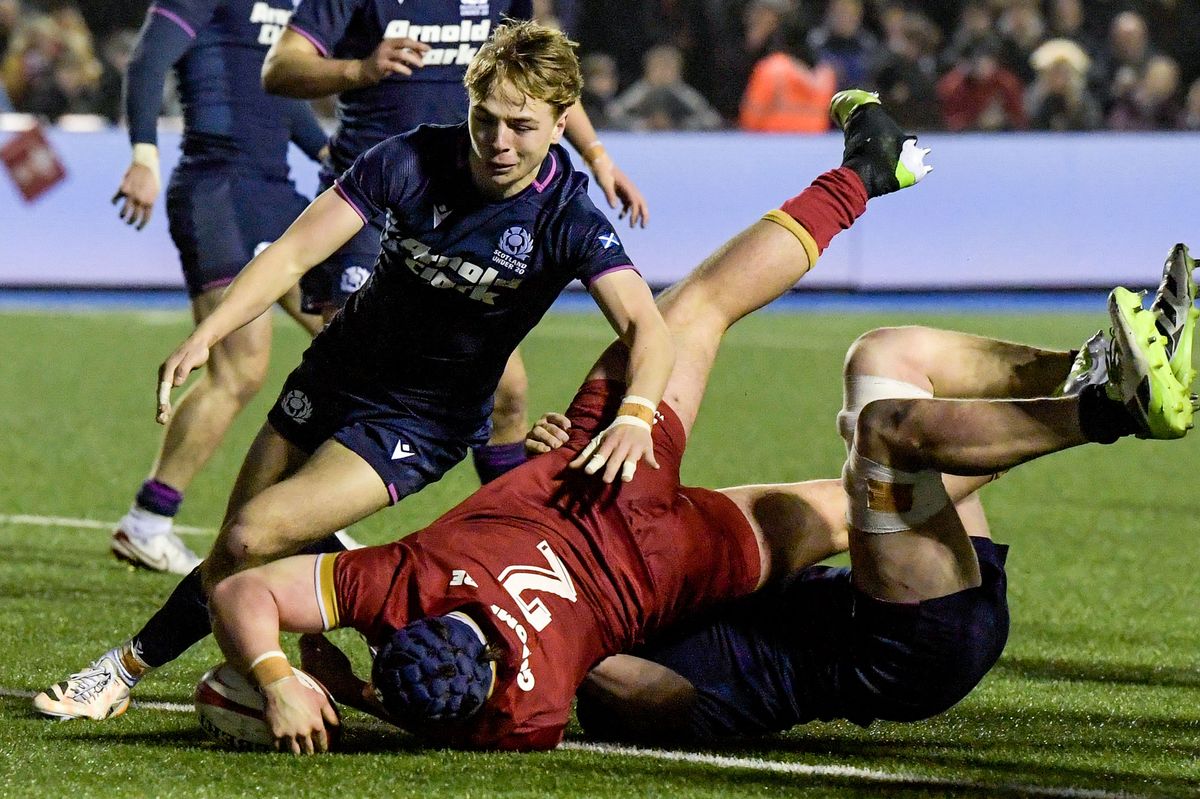 Wales hooker Tome Howe barges his way over