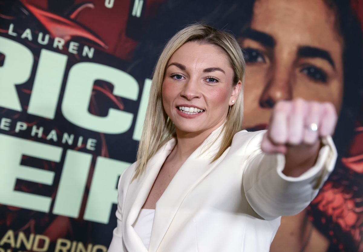 Boxer Lauren Price MBE poses for a photograph in front of a fight poster ahead of her fight with Stephanie Pineiro
