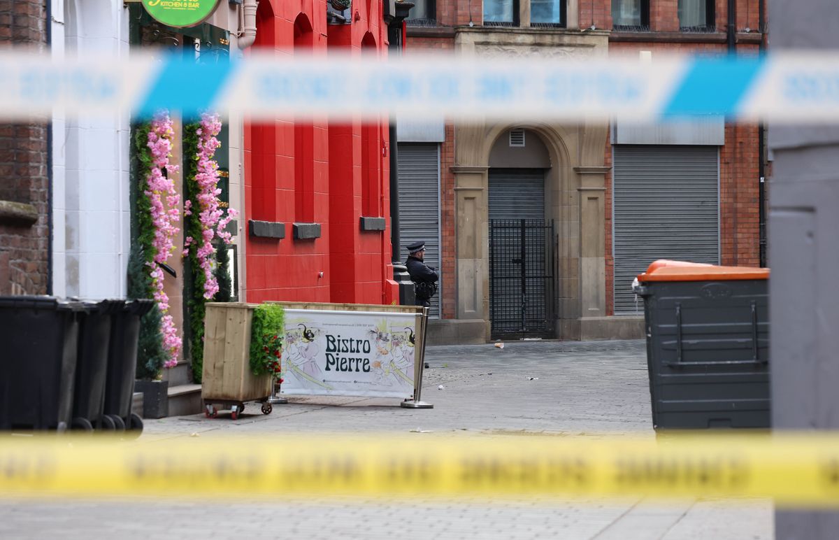 Police officers inside the cordon on Button Street