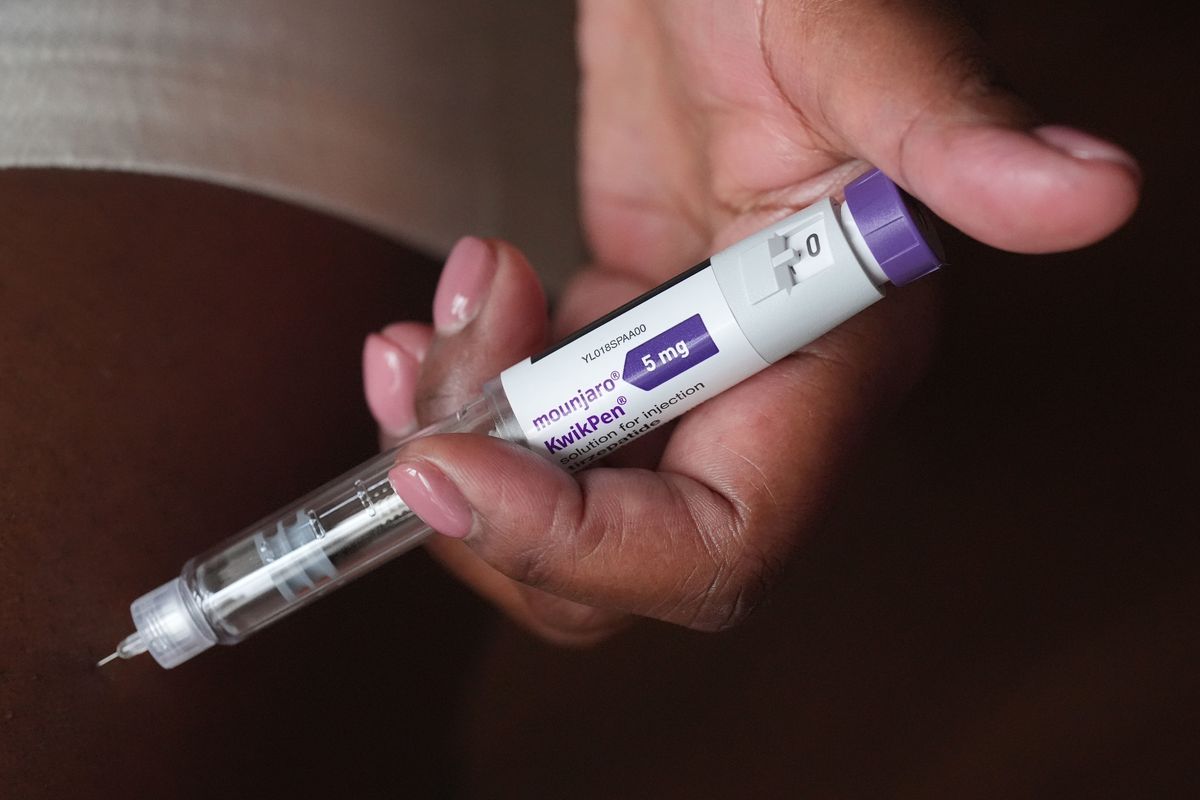 A person uses a 5mg pre-filled injection pen of Mounjaro