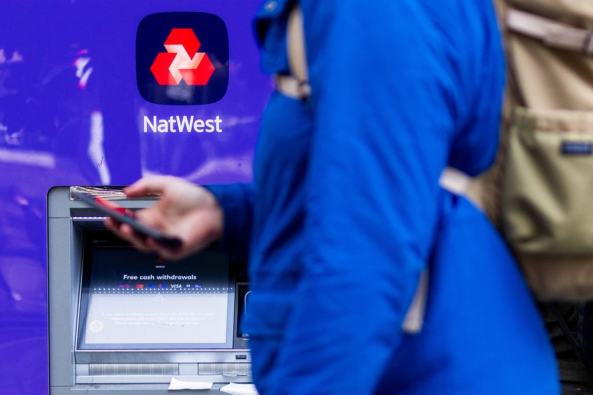 An automated teller machine (ATM) outside a NatWest Group Plc bank branch in London, UK, on Friday, Feb. 6, 2026. NatWest Group Plc agreed to buy wealth manager Evelyn Partners, as the British bank looks to increase its access to affluent clients in its home market. Photographer: Chris Ratcliffe/Bloomberg via Getty Images