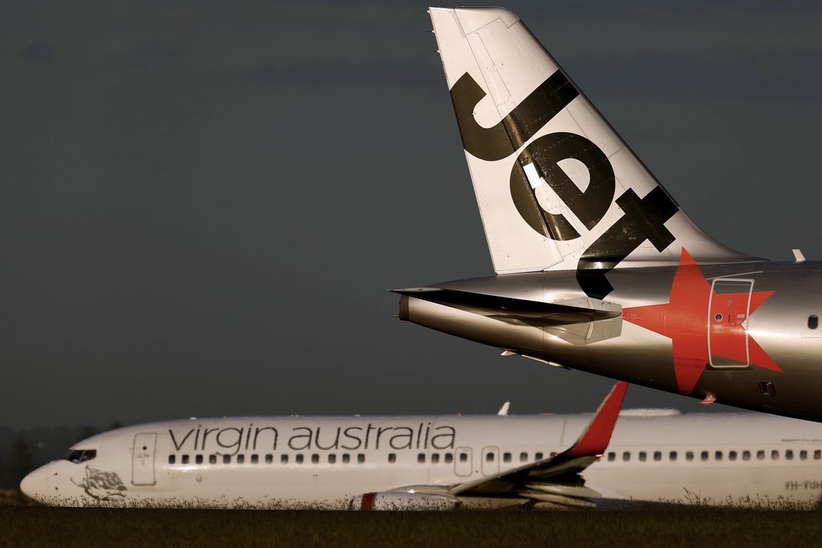 An Airbus aircraft operated by Qantas Airways Ltd.'s low-cost unit Jetstar Airways lands as an aircraft operated by Virgin Australia Holdings Pty Ltd. taxis at Sydney Airport in Sydney, Australia, on Monday, Feb. 24, 2025. Qantas Airways is scheduled to release earnings figures on Feb. 25. Photographer: Brendon Thorne/Bloomberg via Getty Images