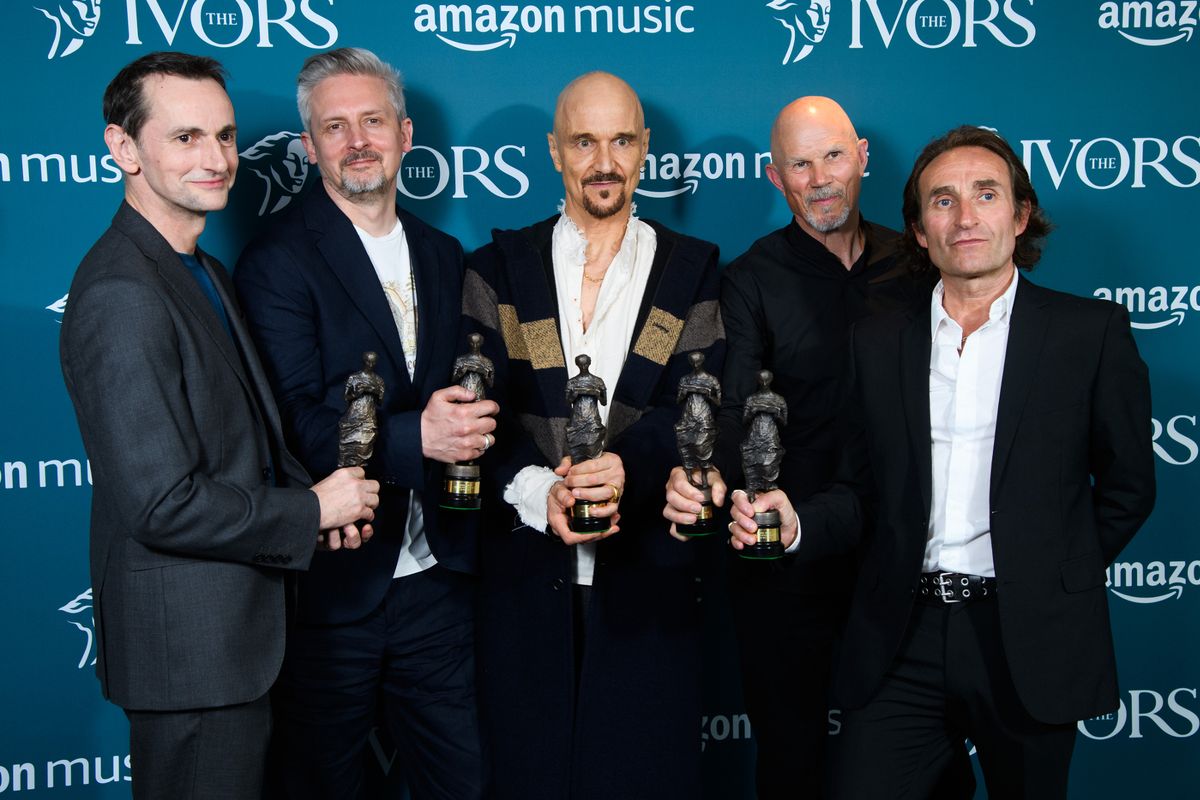  Tim Booth (C) poses with other members of the band James as they win the PRS for Music Icon Award at The Ivors 2023