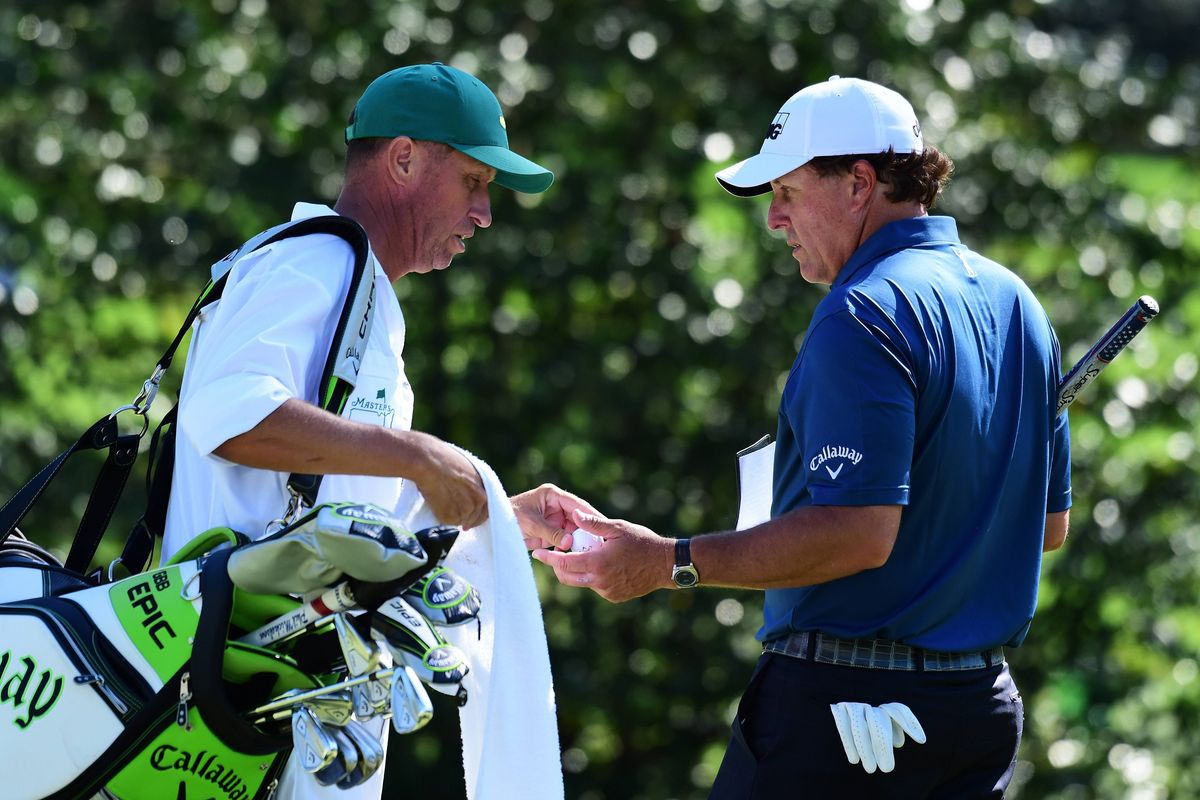 Phil Mickelson of the United States talks with caddie Jim 'Bones' Mackay