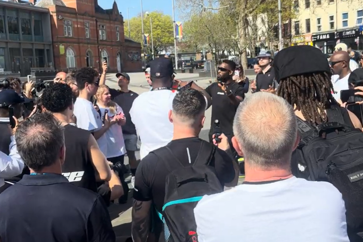 UK rapper Tinie Tempah dressed in a Strava black T-shirt surrounded by a crowd of fans dressed in running gear in Sneinton 