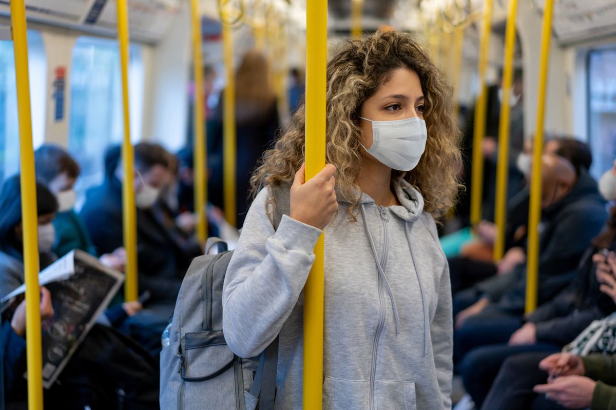 A woman wearing a facemask on public transport