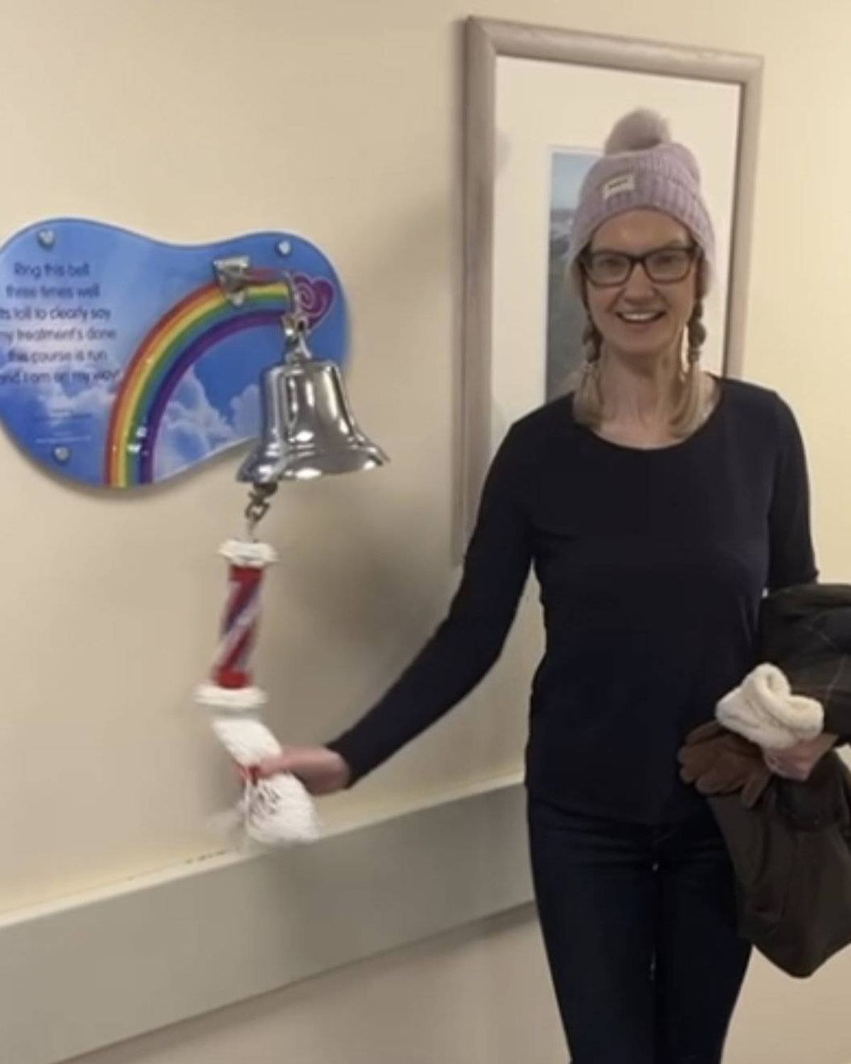 Laura Rowley ringing the end-of-treatment bell