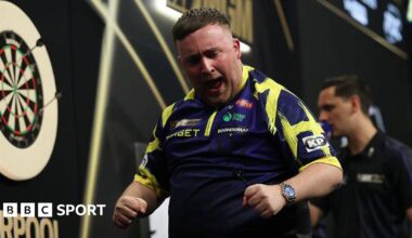 Luke Littler celebrating on the stage