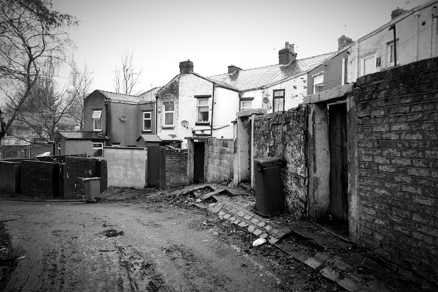 Rear street behind a row of houses.