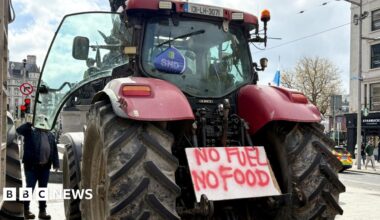 Bethany Norman portrait showing severe eczema and sitting by the hospital bed of her son with her arms are wrapped in bandages
