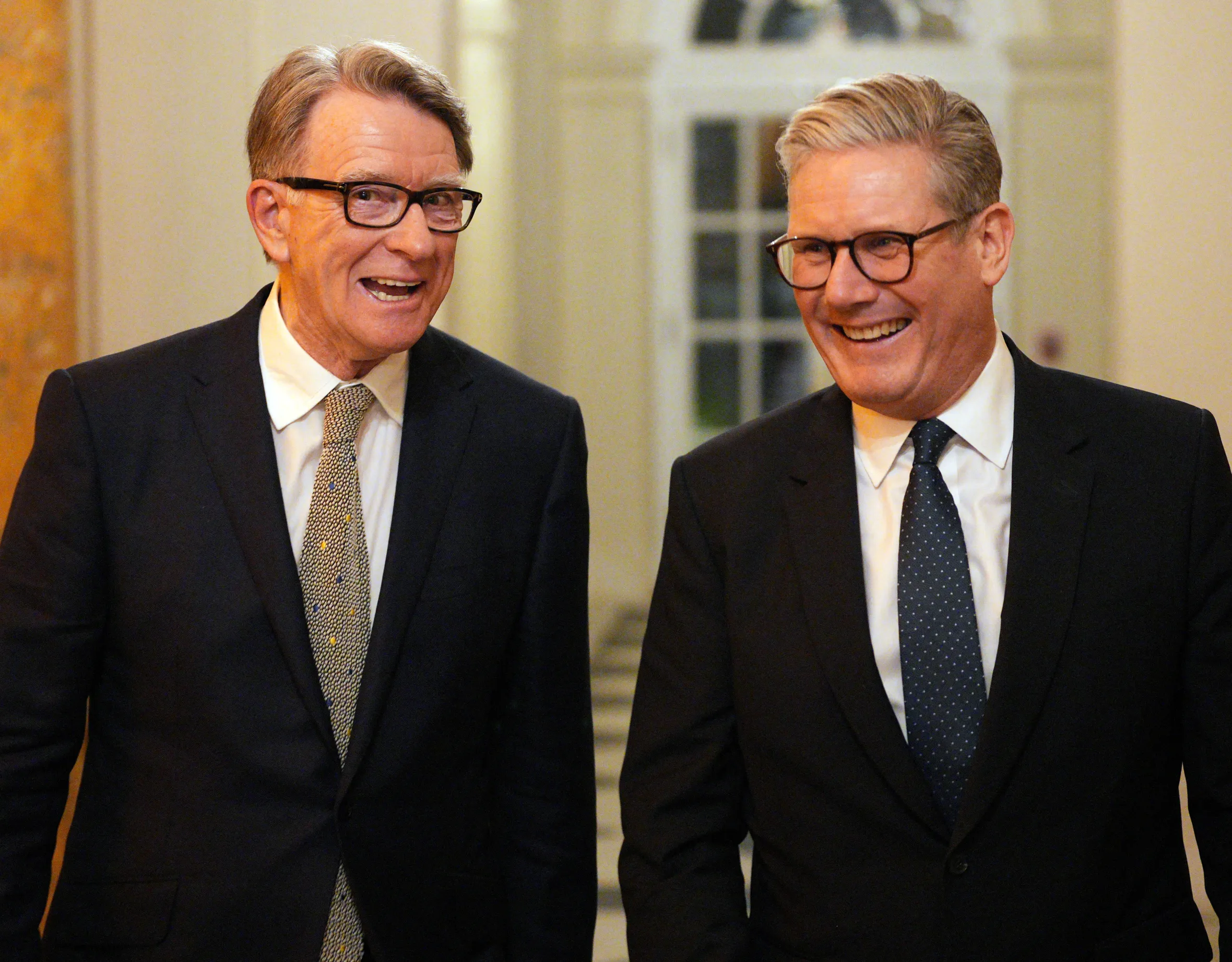 British Prime Minister Keir Starmer and Britain's ambassador to the United States Peter Mandelson smiling.