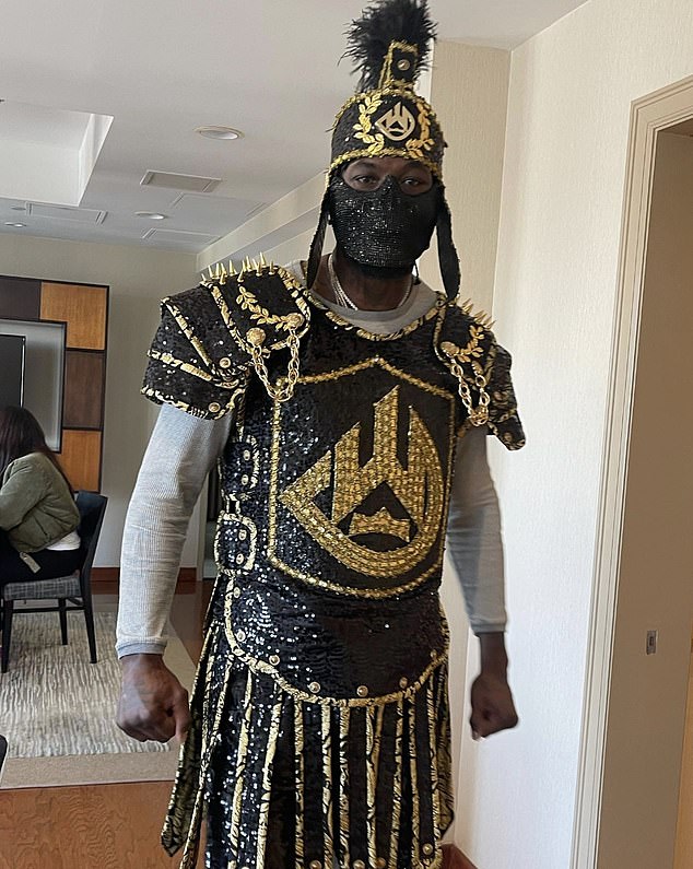 The Bronze Bomber trying on one of his elaborate ring walk costumes