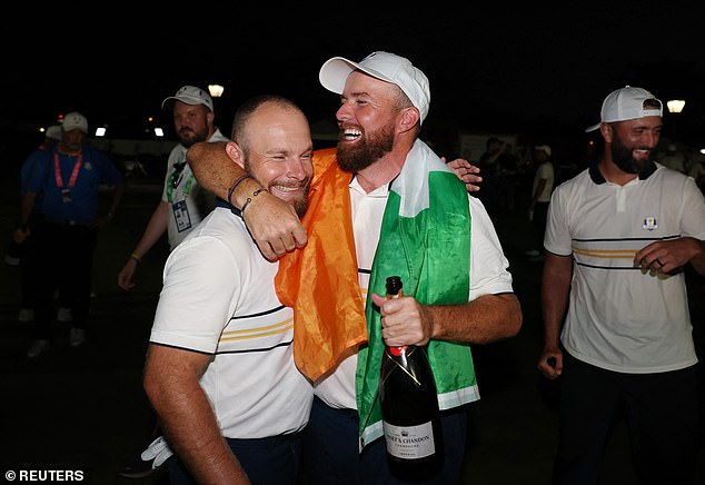 Shane Lowry and Hatton celebrate together after Europe's outright victory was secured