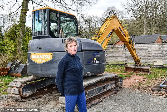 The pair were finally granted planning permission last year after purchasing several thousand pounds worth of 'phosphate credits'. Pictured: Mrs Coyle, on the unfinished site