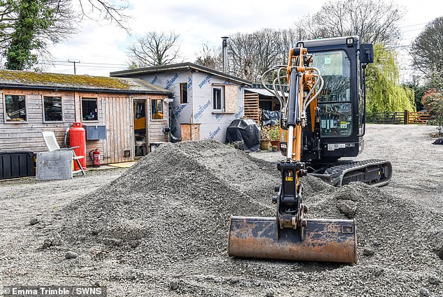 The pair are now part of the biggest ever environmental lawsuit in the UK, as some of around 4,000 people across the area affected by the restrictions. Pictured: The unfinished site of the couple's new home, front, and the shed they currently live in, back