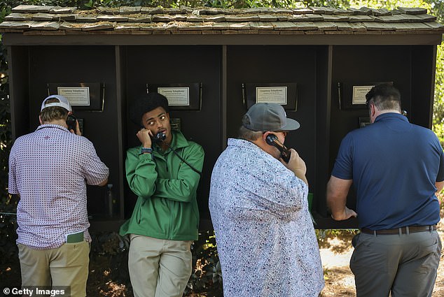 Patrons use a courtesy telephone on the course during the third round of the 2026 Masters Tournament at Augusta National Golf Club on April 11