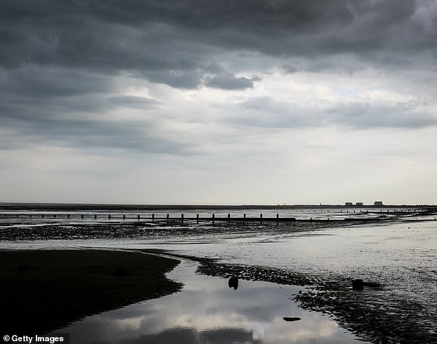 Grey, dreary Littlestone beach at Romney Marsh shows views of the English Channel