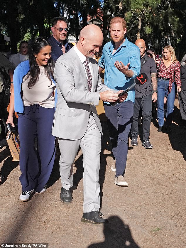 Prince Harry looked annoyed when a reporter asked for a selfie as they left Scar Tree Walk in Melbourne, getting in Meghan's way