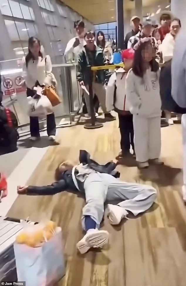 The traveller played dead on the airport floor after brawling with staff