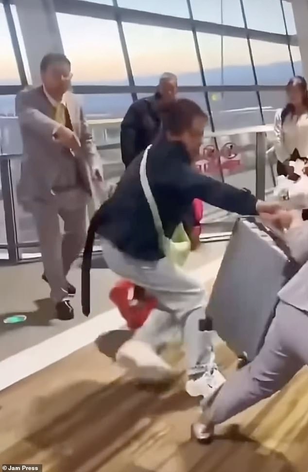 The scene, which took place at at Kunming Changshui International Airport in China, erupted into violence