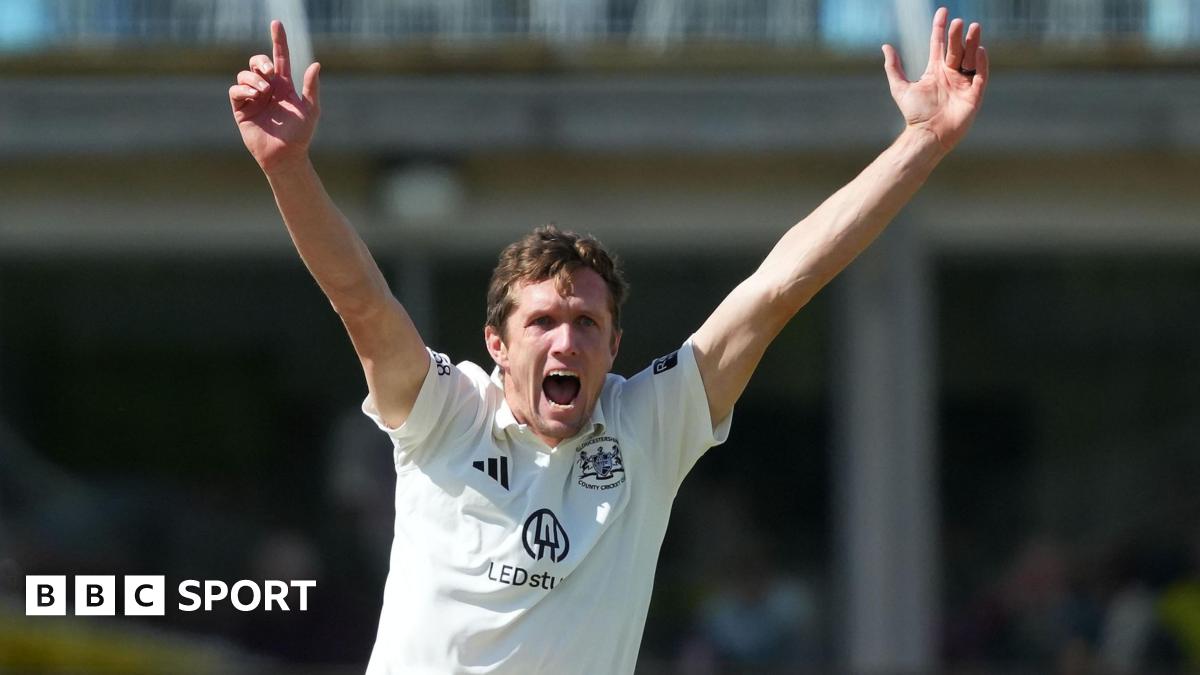 Will Williams with both hands aloft appealing for a wicket for Glocuestershire