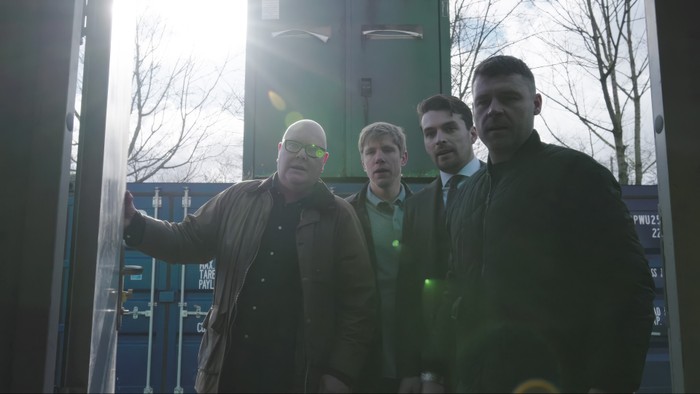 13_03_emm_storage_unit_05 Paddy, Robert, Mack and Aaron stand beside a storage unit in Emmerdale