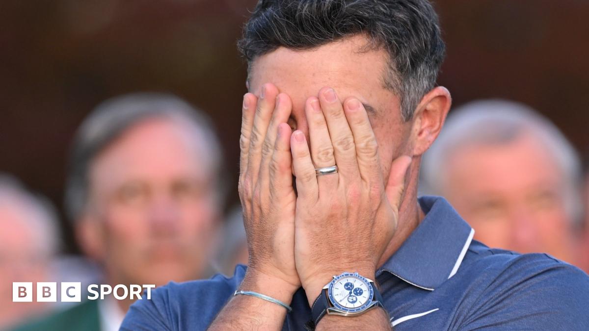 Rory McIlroy covers his face with his hands