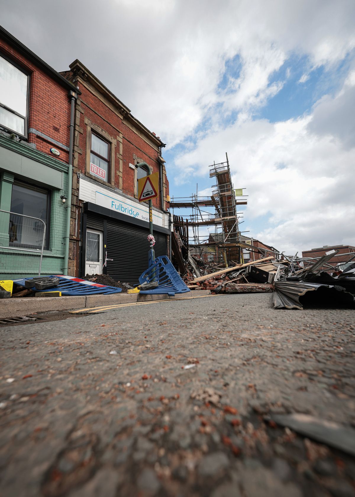 The collapse of the building prompted an evacuation of the surrounding area.
