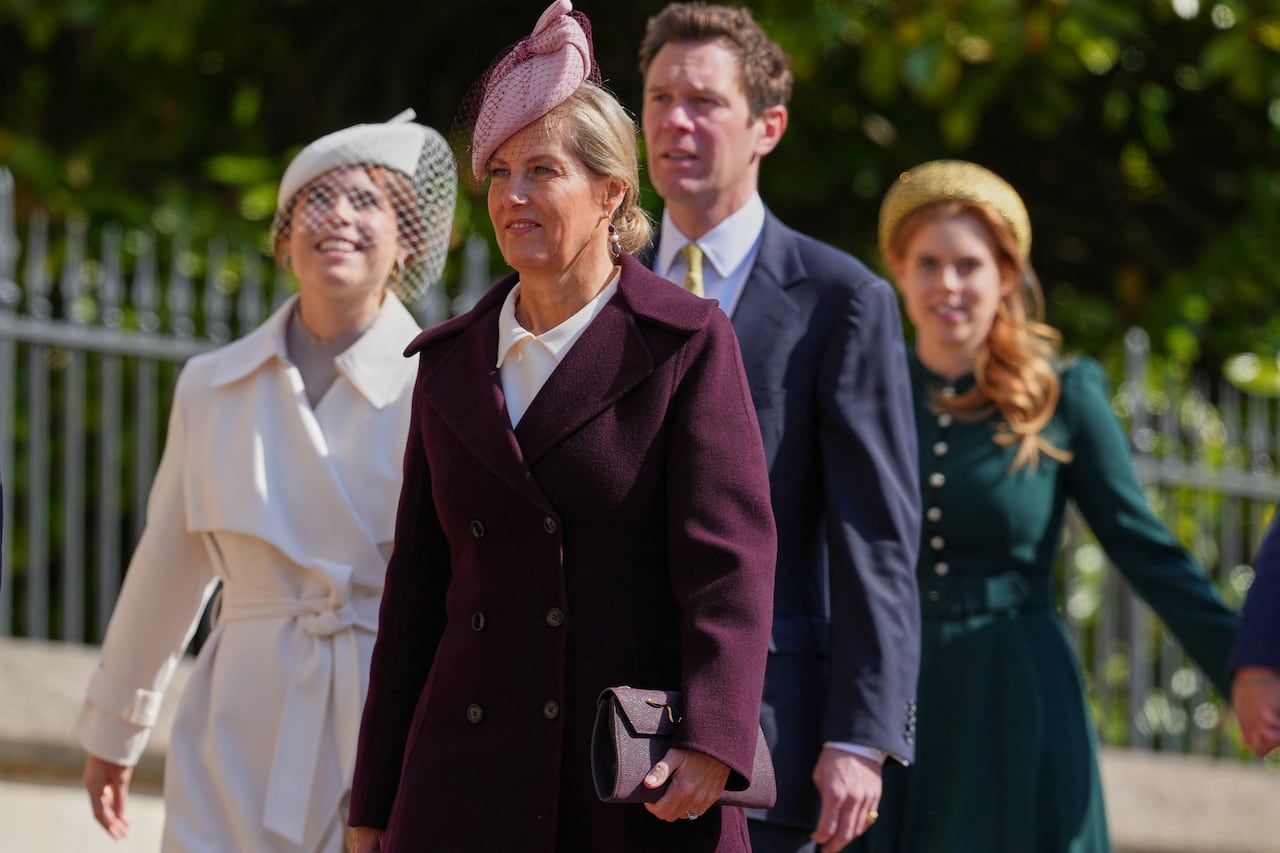 Four people walk together.