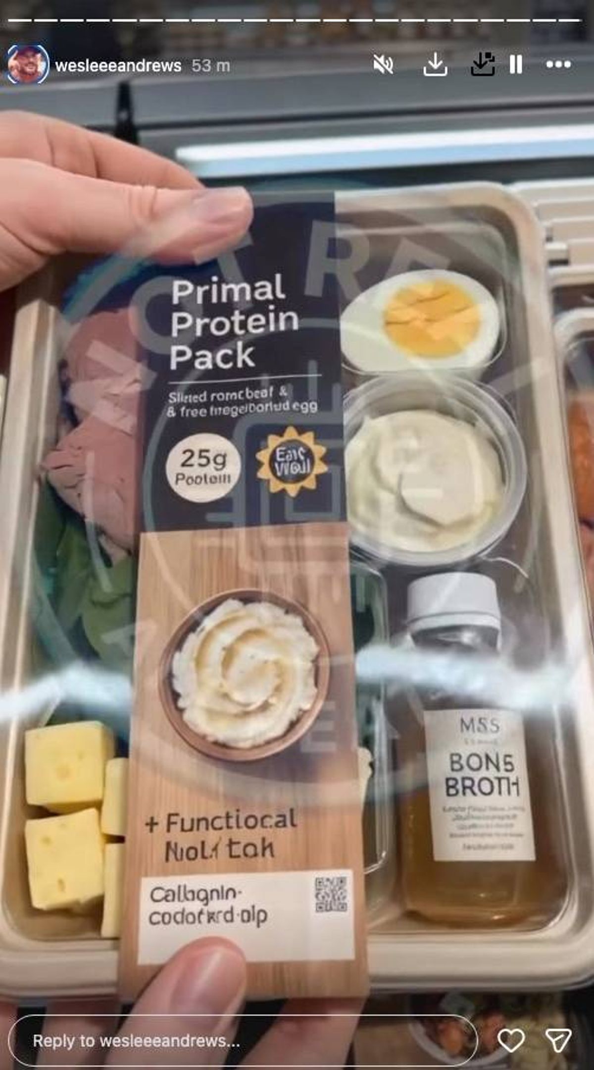 Display of assorted food items in a clear container, including a package of cheese labeled "250g," a bowl of creamy dip, a bottle of dressing, and a small block of cheese.