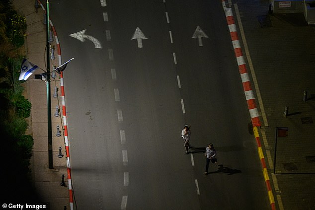 TEL AVIV, ISRAEL - APRIL 10: People run to take shelter as sirens sound during incoming missile fire, without an early warning, allegedly from Hezbollah, just after midnight on the third day of the U.S. Israel Iran Ceasefire on April 10, 2026 in Tel Aviv, Israel. These are the first sirens in Tel Aviv and the surrounding area since the ceasefire has begun. President Donald Trump announced a two-week ceasefire between the US and Iran on his Truth Social platform, conditional on shipping being allowed to resume through the Strait of Hormuz. The IDF has said it will observe the ceasefire with Iran but will continue military targeting Hezbollah in Lebanon. (Photo by Alexi Rosenfeld/Getty Images)