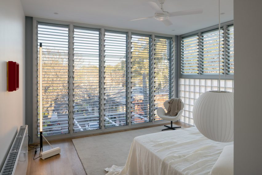 A floor-to-ceiling window opens a bedroom to light and views