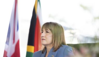 Breaking news update on recent developments in global business trends, featuring a bustling corporate office environment