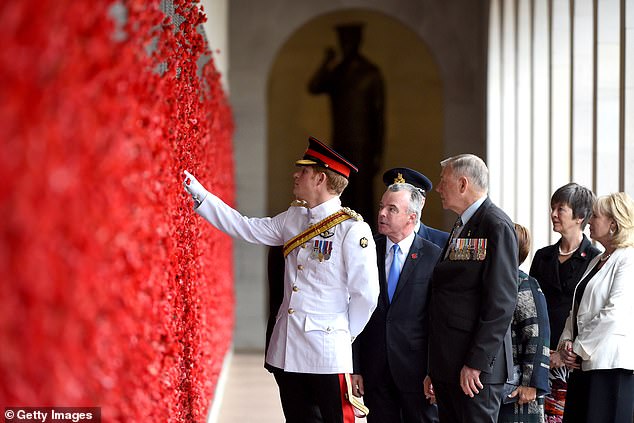 CANBERRA, AUSTRALIA - APRIL 06:  Prince Harry, Director of the Australian War Memorial Brendan Nelson and Chair of the Australian War Memorial Rear Admiral Ken Doolan take a look at the poppies at the Roll of Honour during a visit to the Australian War Memorial on April 6, 2015 in Canberra, Australia. Prince Harry, or Captain Wales as he is known in the British Army, will end his military career with a month long secondment to the Australian Defence Force in barracks in Sydney, Perth and Darwin.  (Photo by Lukas Coch - Pool/Getty Images) 15733681