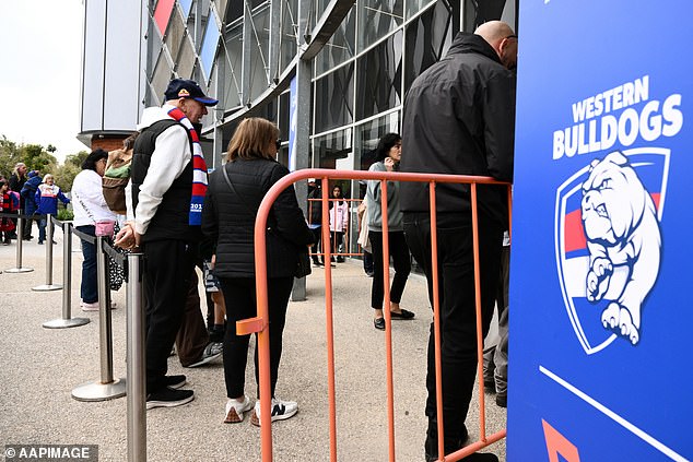 Western Bulldogs supporters wait to enter the ground for a training session as Prince Harry the Duke of Sussex visits with the Movember Foundation at the Western Bulldogs headquarters, Whitten Oval in Melbourne, Wednesday, April 15, 2026. (AAP Image/Joel Carrett) NO ARCHIVING