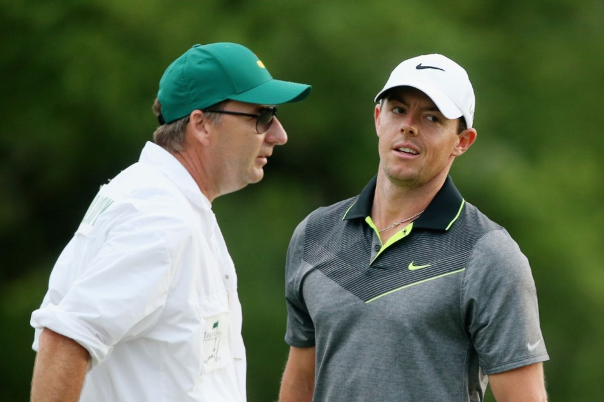 Rory McIlroy of Northern Ireland and his caddie J.P. Fitzgerald on the 18th green during the second round of the 2015 Masters Tournament at Augusta National Golf Club